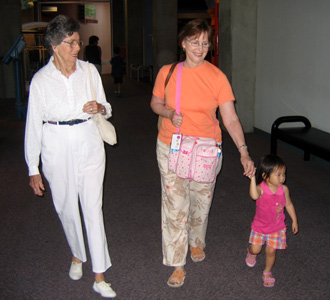 Walking through the Museum of Science with Great Grandma Mimi and Grandma Linda